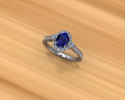 This classic looking sapphire ring is crafted with white gold and diamond embellishments to create a halo around the center stone. 