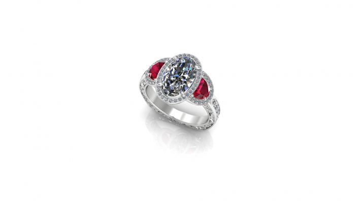 This elegant ring displays an oval cut diamond alongside two sparkling rubies.  A ring fit for a princess this custom engagement ring is the perfect display of love. 