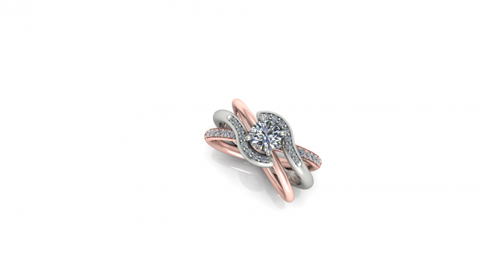 This beautiful ring features a unique design with both rose gold and white gold.  As three bands come together in a nebula of twinkling diamonds, a .8 karat round diamond shines brightly as the center stone among the rest. 