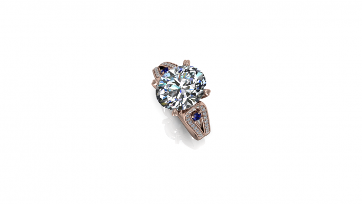 This stunning custom design places a breathtaking oval diamond at the center of its display.  Encompassed in a rose gold band, this ring holds an array of beautiful complimenting diamonds along with two sapphires to add a subtle hint of color. 